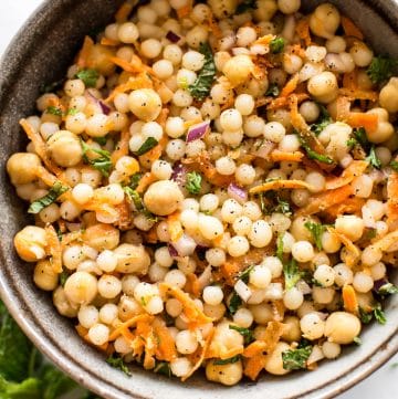 This healthy vegan pearl couscous salad has delicious fresh herbs, chickpeas, and carrots. It's the perfect light lunch or meal prep recipe.