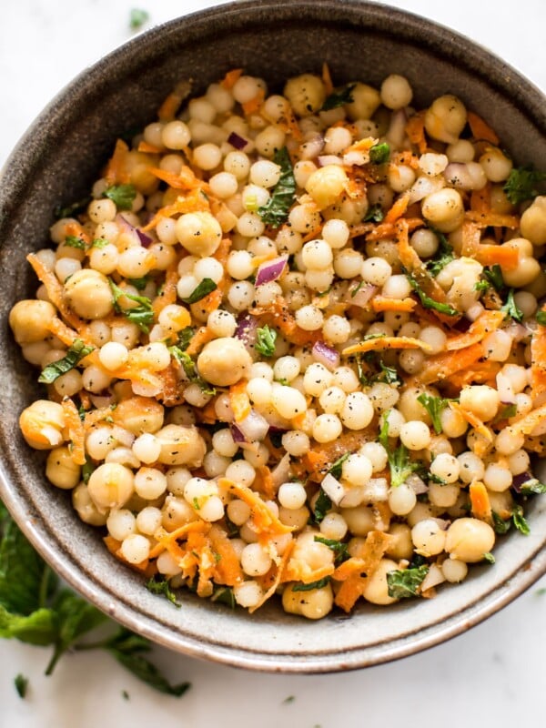 This healthy vegan pearl couscous salad has delicious fresh herbs, chickpeas, and carrots. It's the perfect light lunch or meal prep recipe.