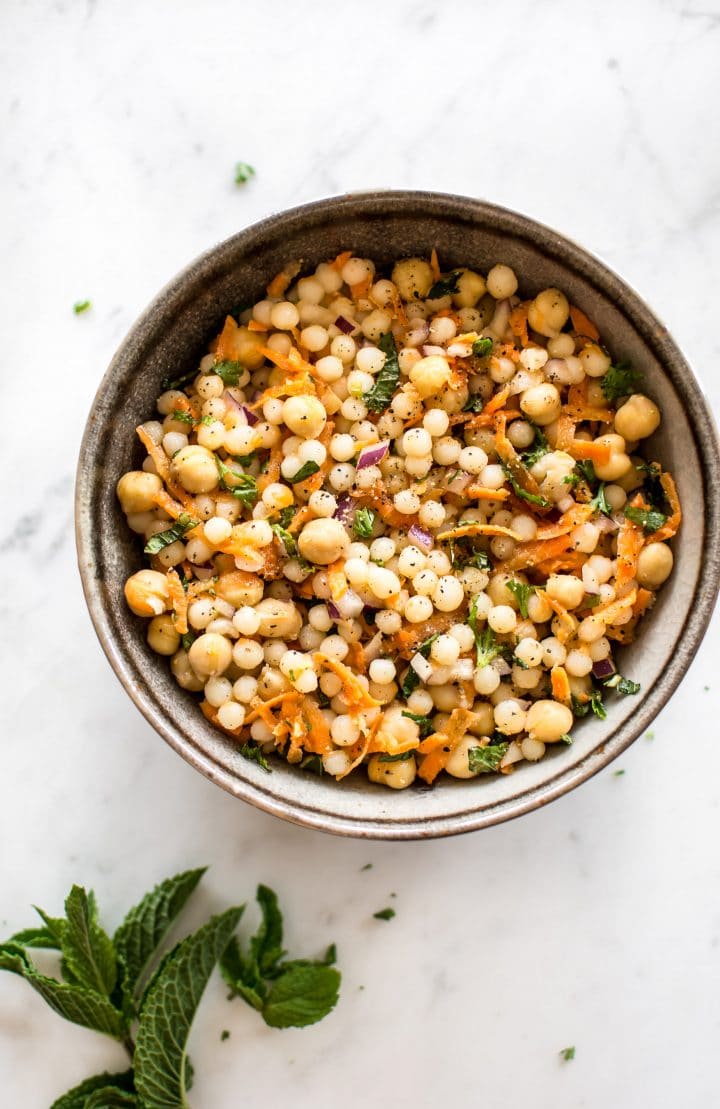 This healthy vegan pearl couscous salad has delicious fresh herbs, chickpeas, and carrots. It's the perfect light lunch or meal prep recipe.