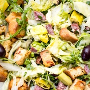 This Italian chopped salad recipe is easy, fast, and fresh. Salami, homemade croutons, and pepperoncini peppers make this one flavorful salad! 