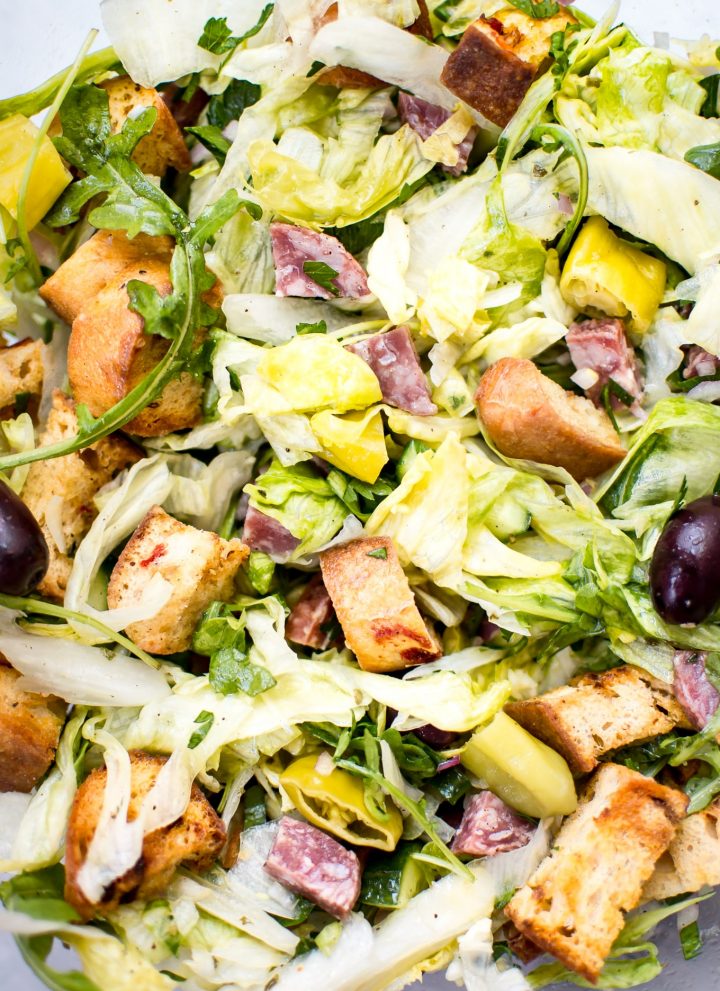 This Italian chopped salad recipe is easy, fast, and fresh. Salami, homemade croutons, and pepperoncini peppers make this one flavorful salad! 