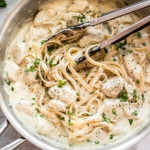 This easy chicken Alfredo recipe has a lemon, garlic, and parmesan cream sauce. It is so quick and simple to make cheesy homemade Alfredo sauce from scratch! Total comfort food. Serve with fettuccine or any kind of pasta.