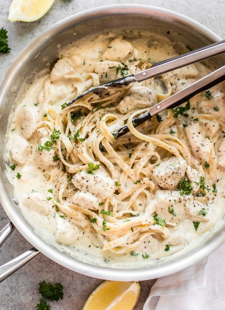 This easy chicken Alfredo recipe has a lemon, garlic, and parmesan cream sauce. It is so quick and simple to make cheesy homemade Alfredo sauce from scratch! Total comfort food. Serve with fettuccine or any kind of pasta.