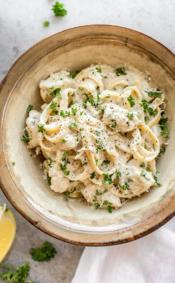 earthenware bowl of creamy garlic chicken alfredo