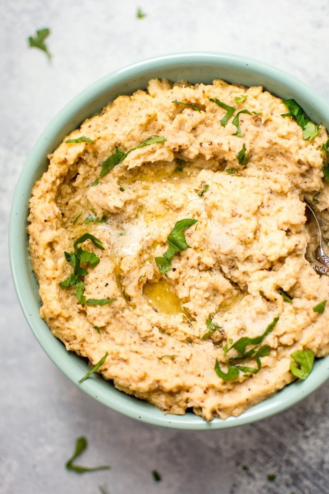 close-up of roasted mashed cauliflower in a teal bowl