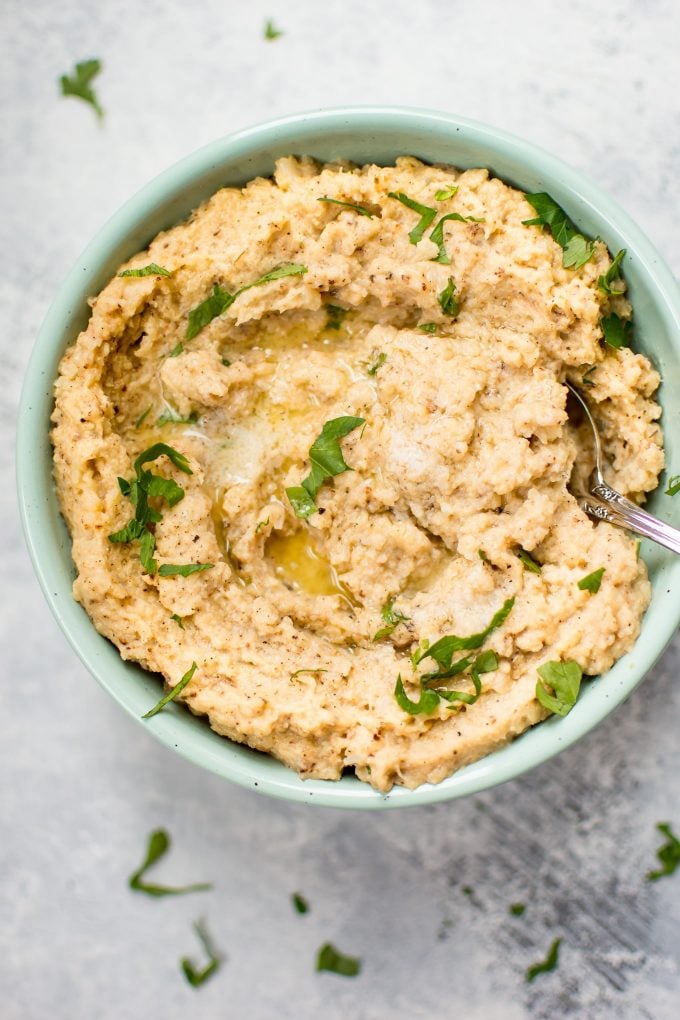 bowl of roasted mashed cauliflower with a spoon