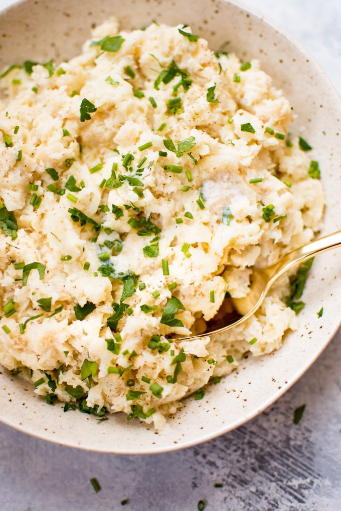 rustic parsnip mash in a bowl with a spoon close-up