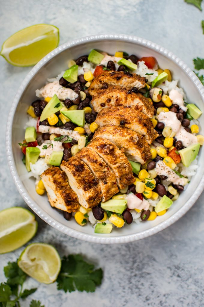 spicy chicken taco bowl beside lime wedges