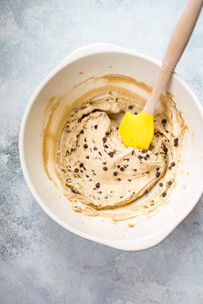 mixing bowl with vegan chocolate chip cookie dough frosting with spatula