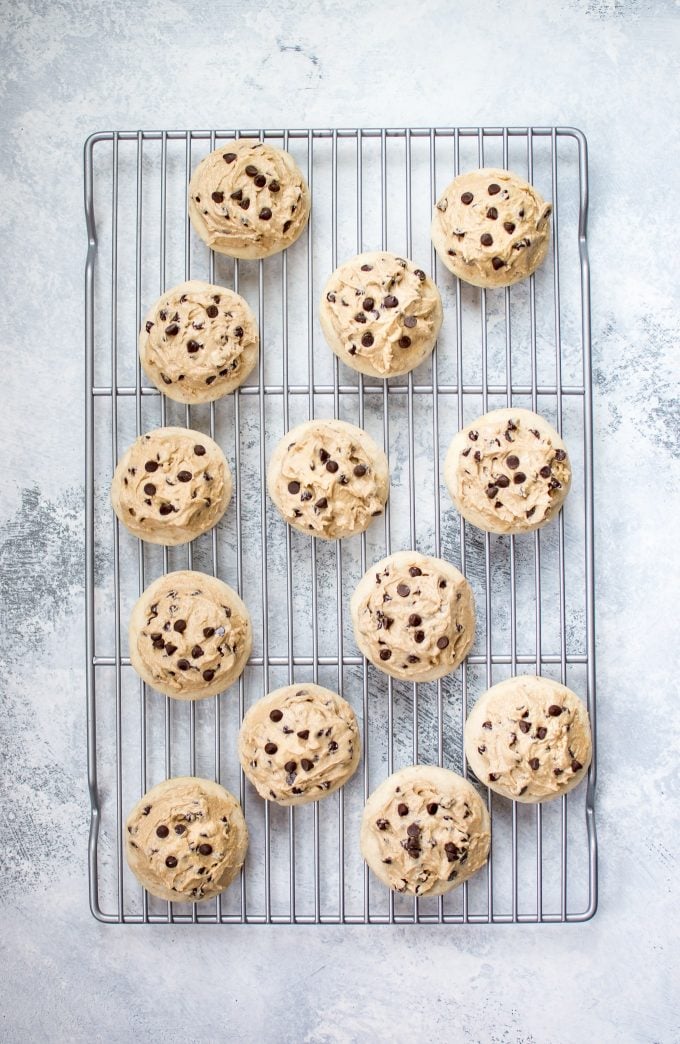 vegan chocolate chip sugar cookies with frosting on a wire rack