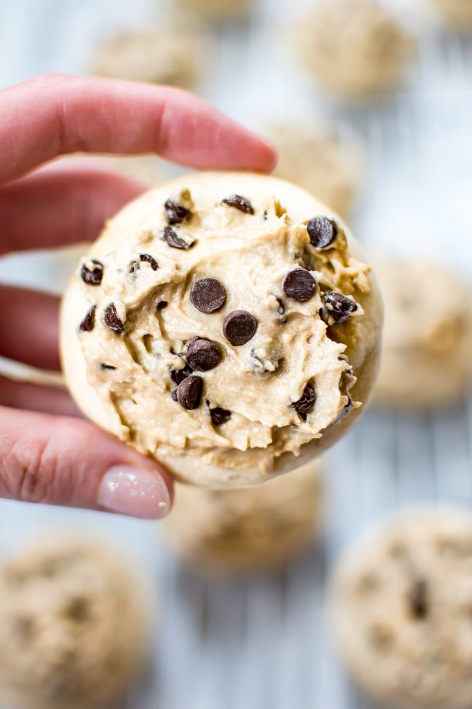 female hand holding a vegan sugar cookie with frosting