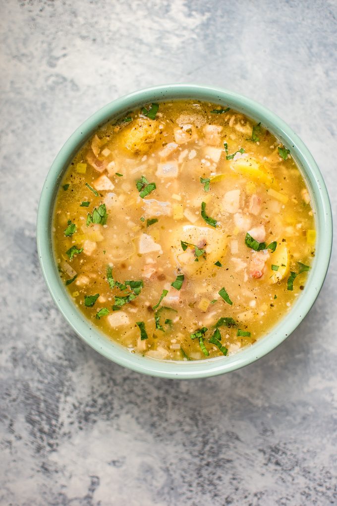 white bean and potato soup with pancetta in a teal bowl