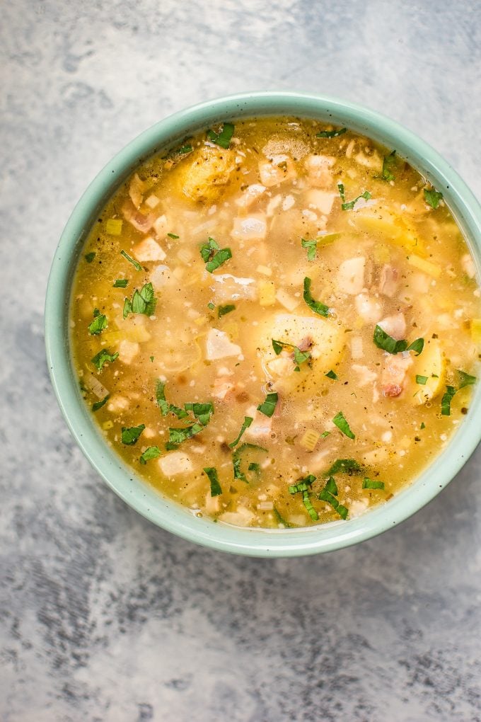 teal bowl with white bean soup with potatoes and pancetta