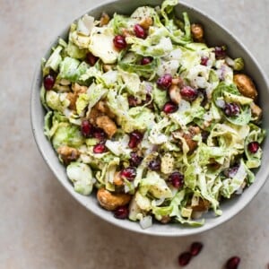 This winter Brussels sprouts slaw is loaded with goodies like candied cashews and pomegranate arils. A gorgeous side dish perfect for the holidays!