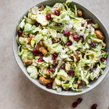 This winter Brussels sprouts slaw is loaded with goodies like candied cashews and pomegranate arils. A gorgeous side dish perfect for the holidays!