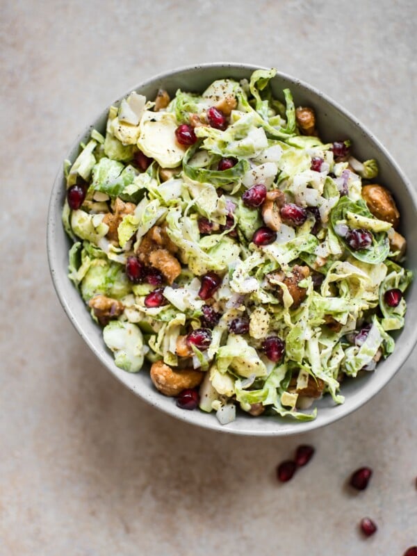 This winter Brussels sprouts slaw is loaded with goodies like candied cashews and pomegranate arils. A gorgeous side dish perfect for the holidays!