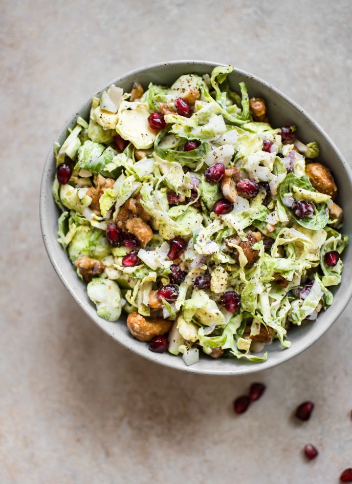 This winter Brussels sprouts slaw is loaded with goodies like candied cashews and pomegranate arils. A gorgeous side dish perfect for the holidays!