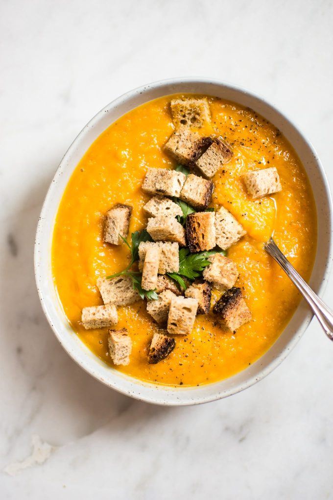 simple butternut squash and carrot soup in a bowl with a spoon