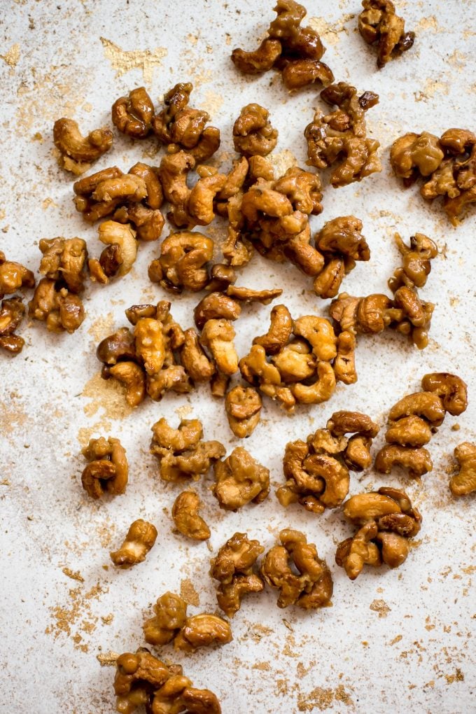 close-up of loose candied cashews on a flat surface