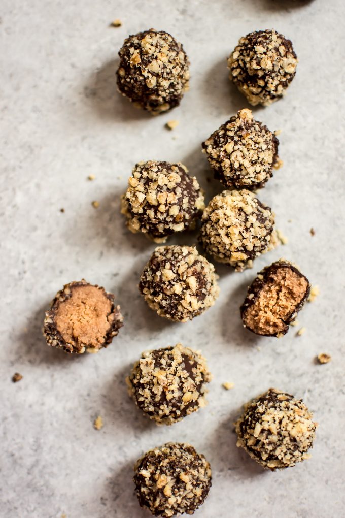 several easy coconut rum truffles with one broken in half