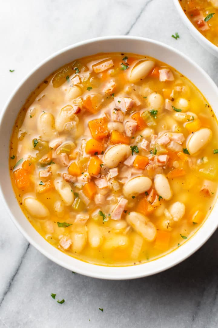 ham and white bean soup in two white bowls