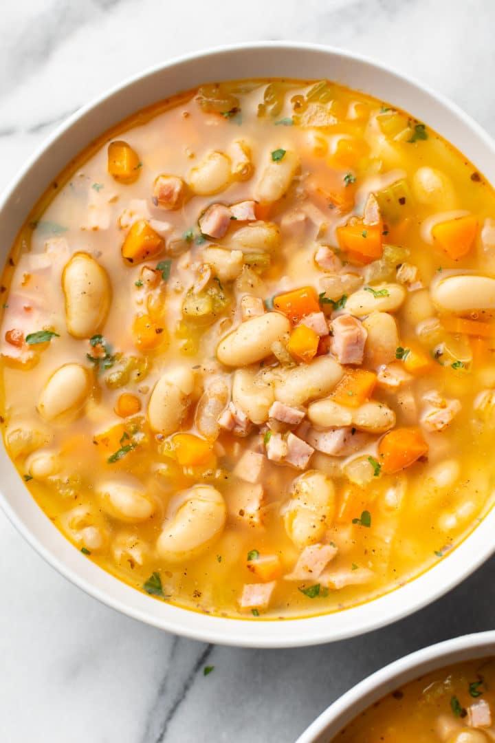 ham and bean soup (close-up in a white bowl)