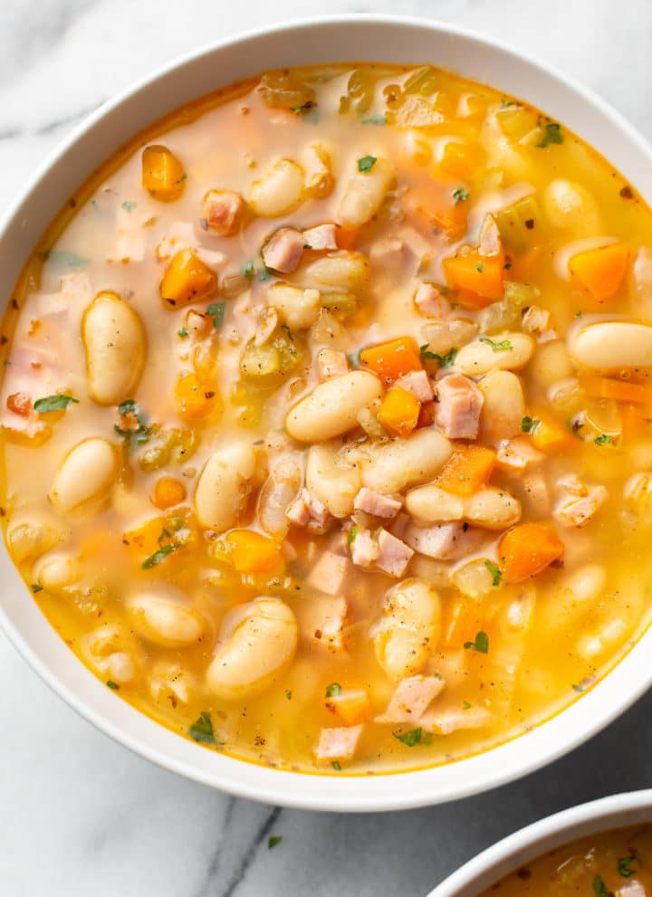 ham and bean soup (close-up in a white bowl)