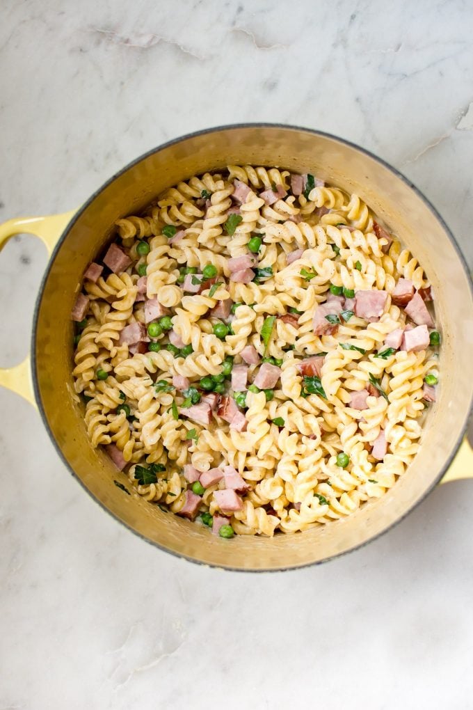 yellow cooking pot with leftover ham and pea pasta