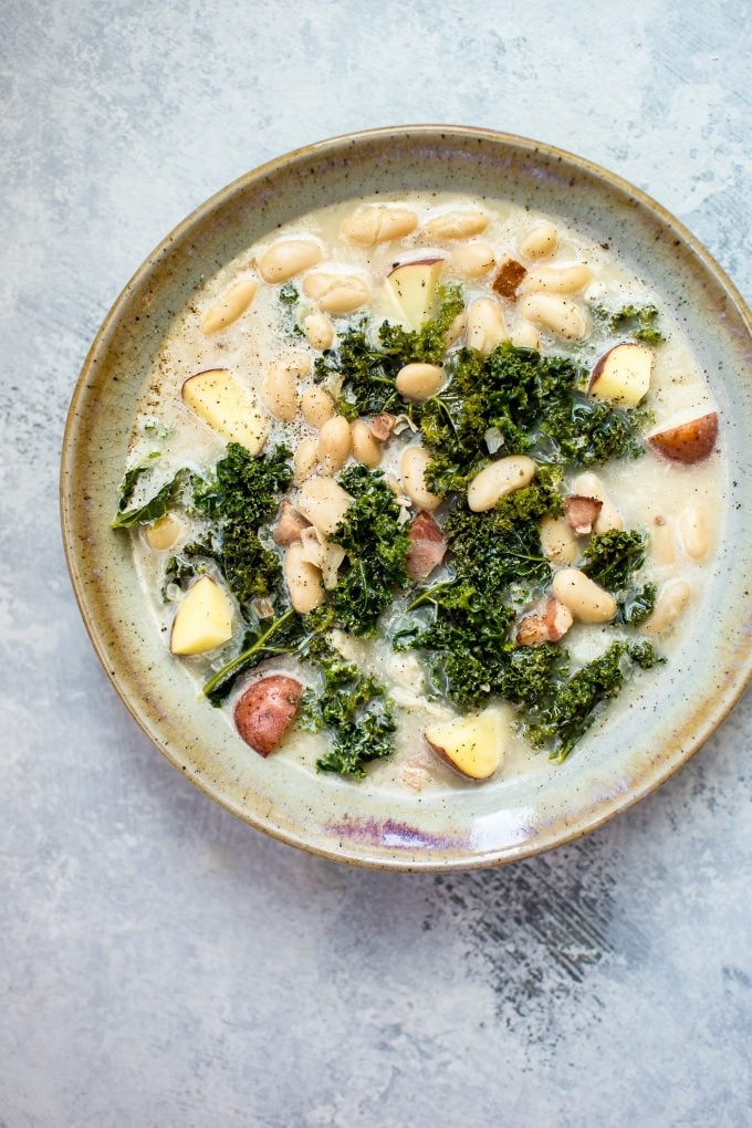 stoneware bowl of white bean kale soup