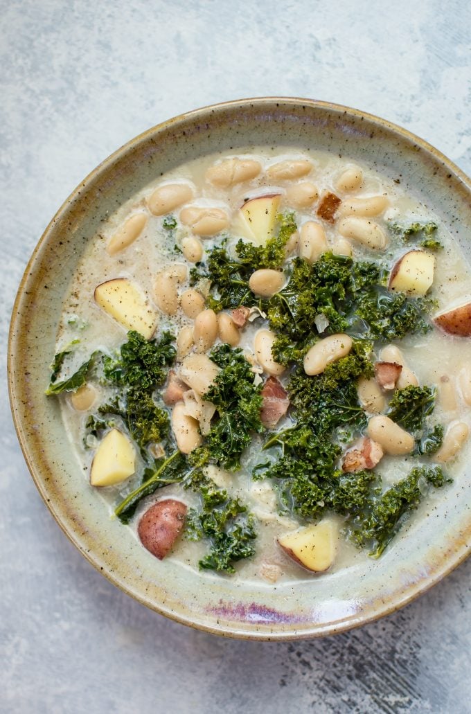 close-up of cozy white bean kale soup in a bowl