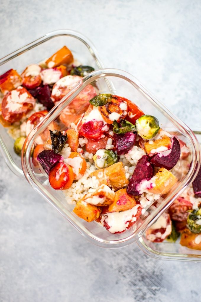 glass meal prep containers filled with roasted vegetable salad