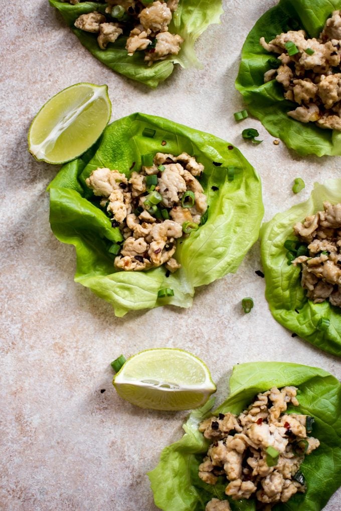 sweet chili chicken lettuce wraps with lime wedges