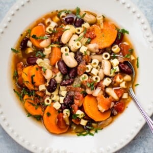 This Crockpot vegetarian pasta e fagioli soup recipe is a hearty and flavorful meatless meal that is easy to throw together so you have a hot meal ready when you get home!