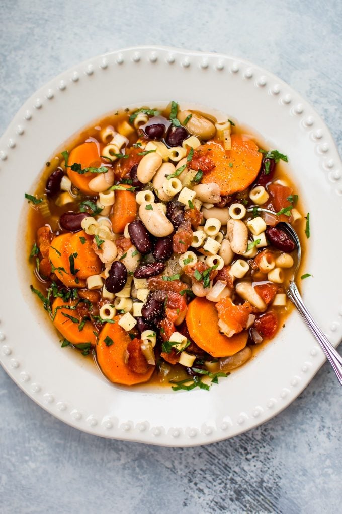 bowl of vegetarian Italian pasta and beans soup with spoon