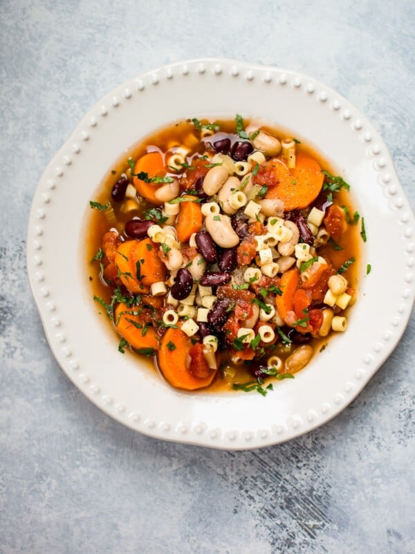 This Crockpot vegetarian pasta e fagioli soup recipe is a hearty and flavorful meatless meal that is easy to throw together so you have a hot meal ready when you get home!