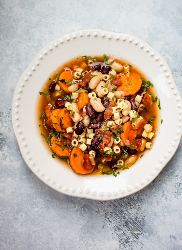 This Crockpot vegetarian pasta e fagioli soup recipe is a hearty and flavorful meatless meal that is easy to throw together so you have a hot meal ready when you get home!