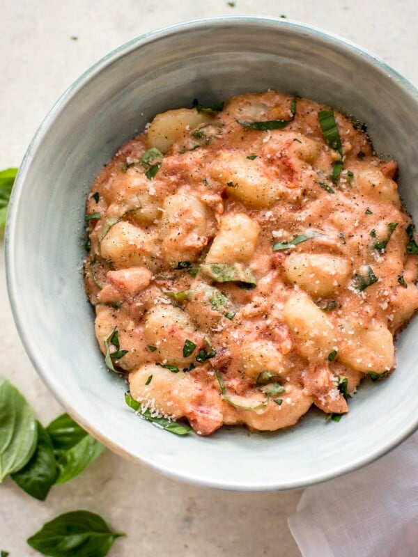 Gnocchi in a vodka cream sauce with tomatoes and basil. This gnocchi alla vodka recipe is ready in about 20 minutes! A delicious weeknight dinner.