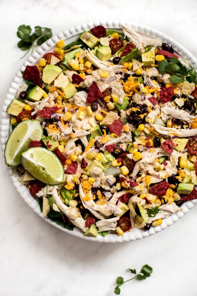 healthy chicken taco salad recipe with fresh vegetables in a white bowl