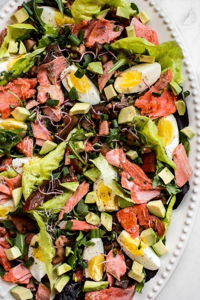 close-up of lighter salmon Cobb salad recipe on oval plate