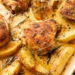 a sheet pan with chicken thighs and potatoes