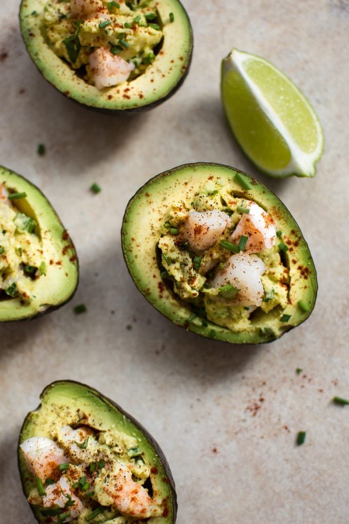 shrimp stuffed avocados beside a lime wedge