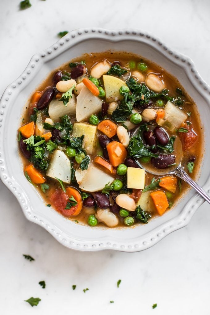 close-up of easy vegetable and bean soup in a bowl with a spoon