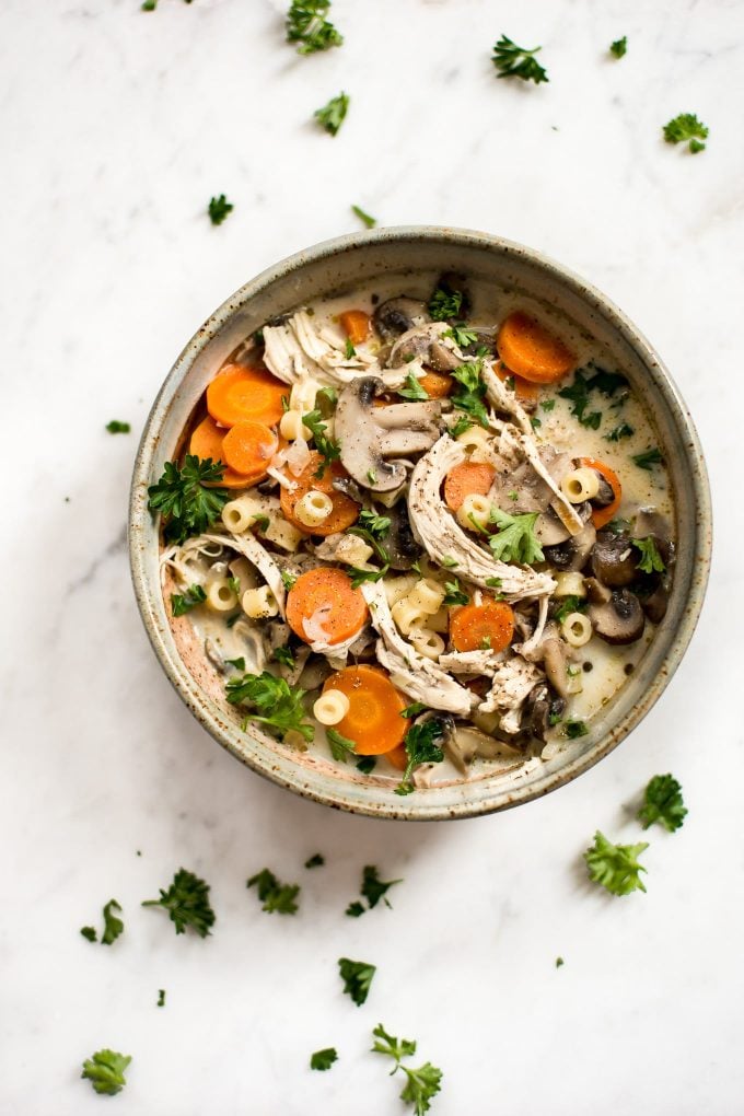 bowl of chicken mushroom soup on marble surface