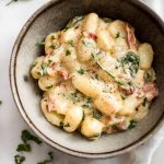 You will love this creamy gnocchi with sun-dried tomatoes and basil! It's a super easy and decadent 15 minute recipe that you'll want to devour again and again.