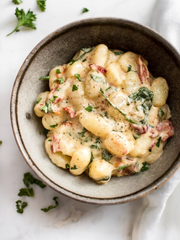 You will love this creamy gnocchi with sun-dried tomatoes and basil! It's a super easy and decadent 15 minute recipe that you'll want to devour again and again.