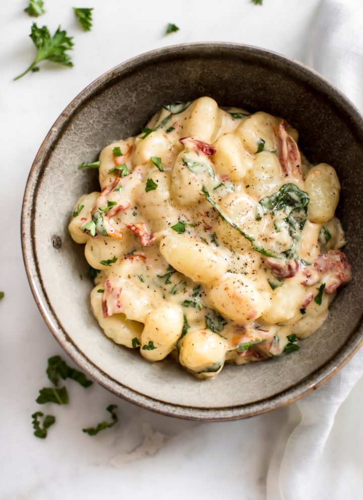 You will love this creamy gnocchi with sun-dried tomatoes and basil! It's a super easy and decadent 15 minute recipe that you'll want to devour again and again.
