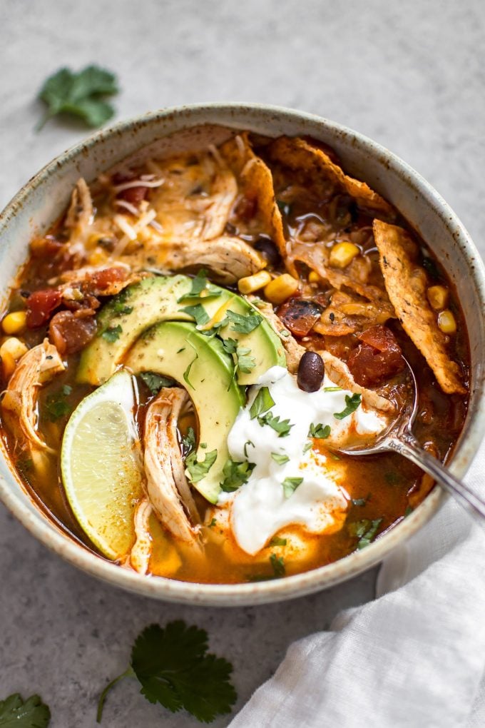 close-up of easy Instant Pot chicken tortilla soup in a bowl with a spoon