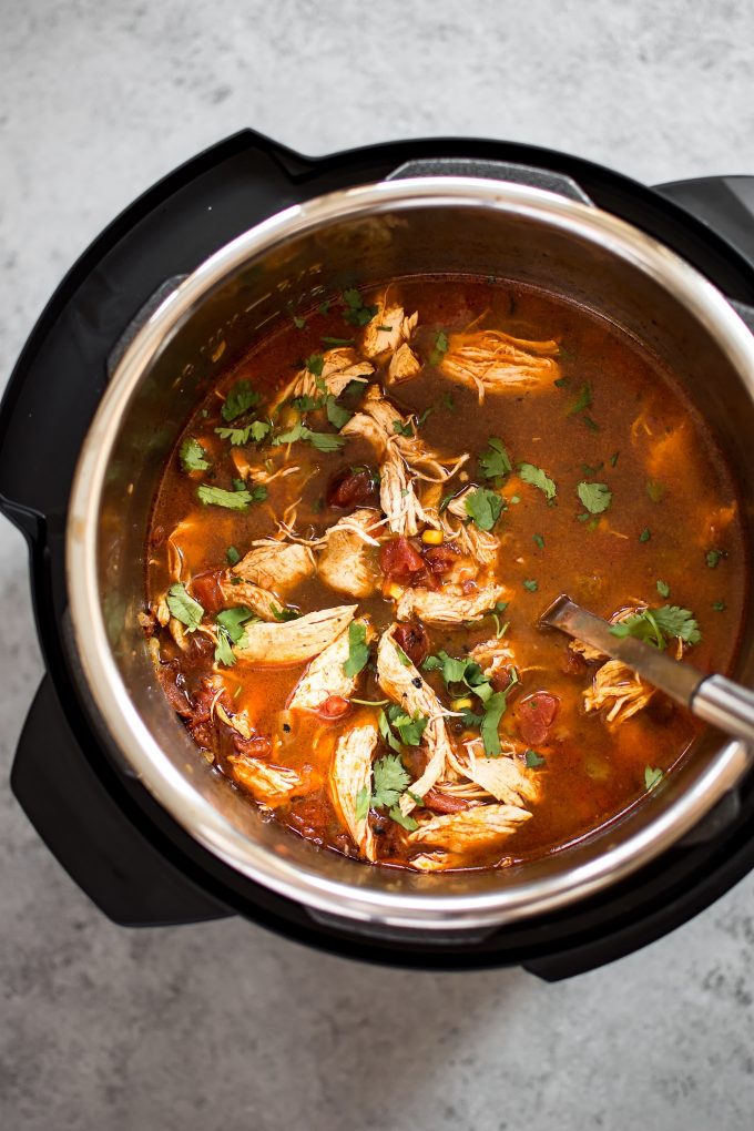 easy chicken tortilla soup inside an Instant Pot with a ladle