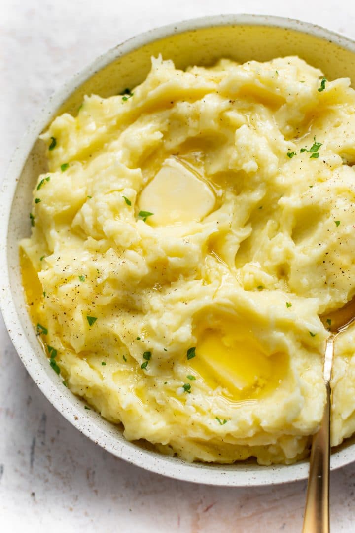 close-up of creamy Instant Pot mashed potatoes with pools of melted butter