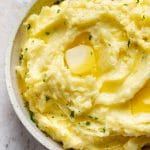 Instant Pot mashed potatoes in a serving bowl with plenty of butter